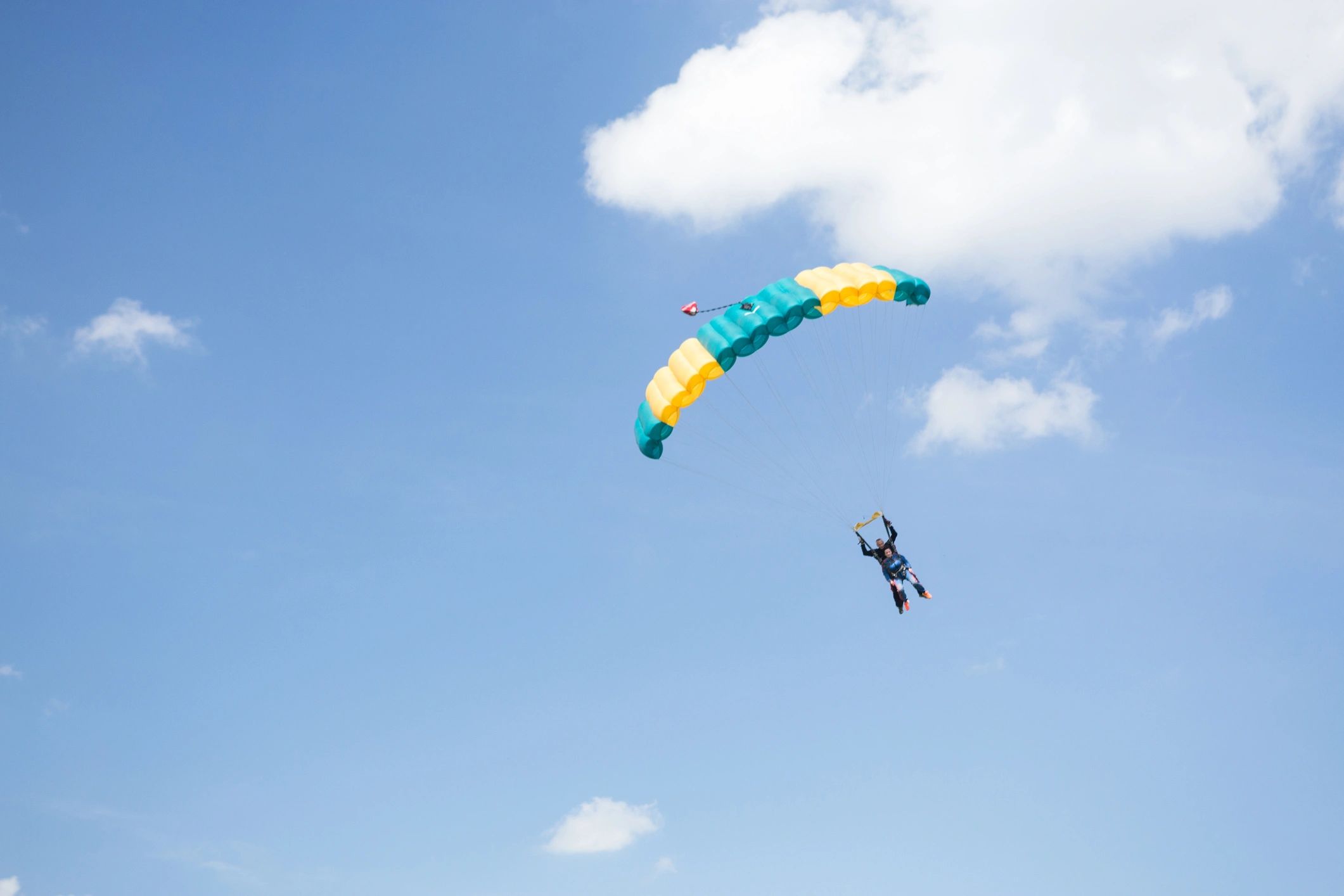 Tandem pair descending under an open parachute