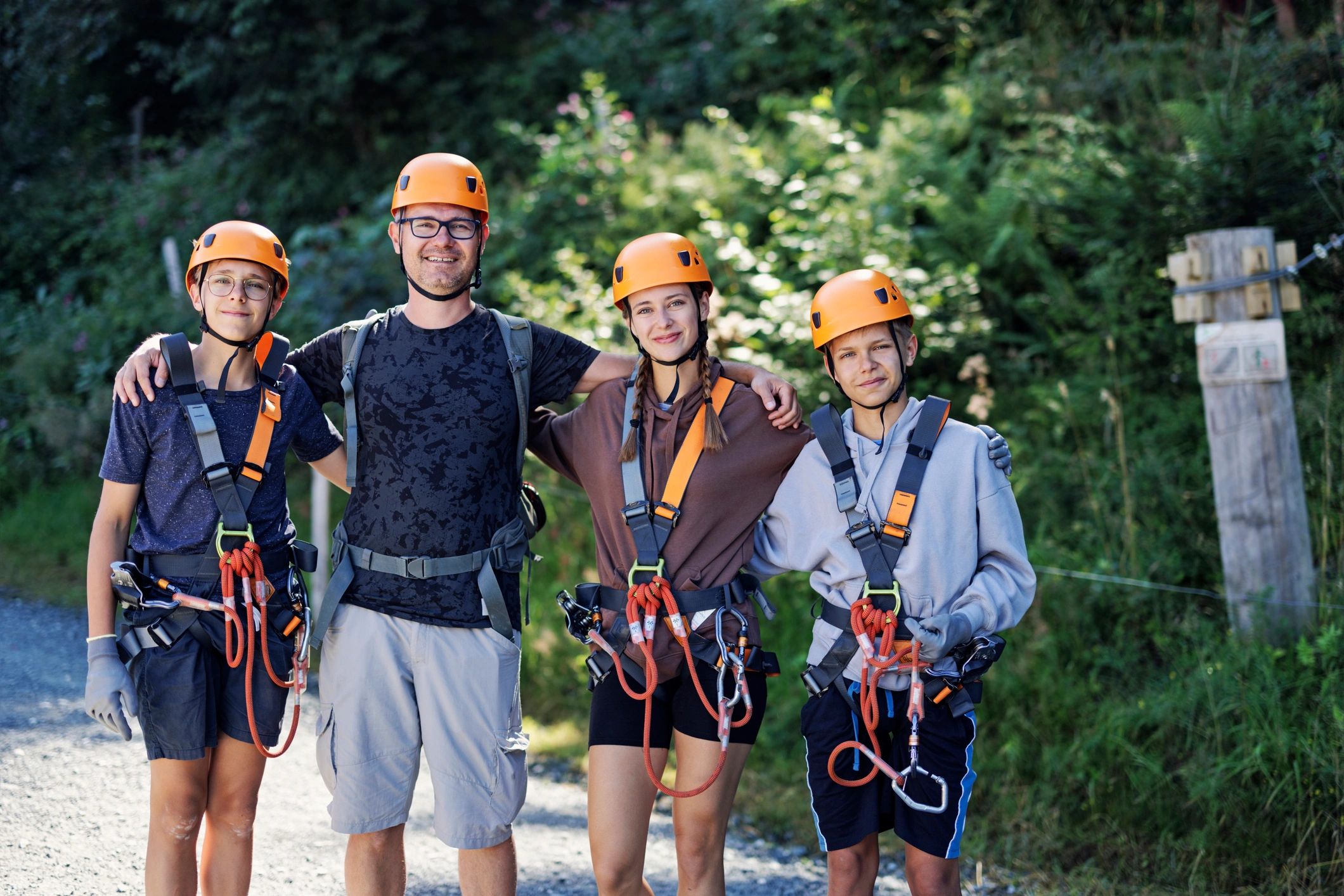 Adventure team members smiling outdoors in safety gear