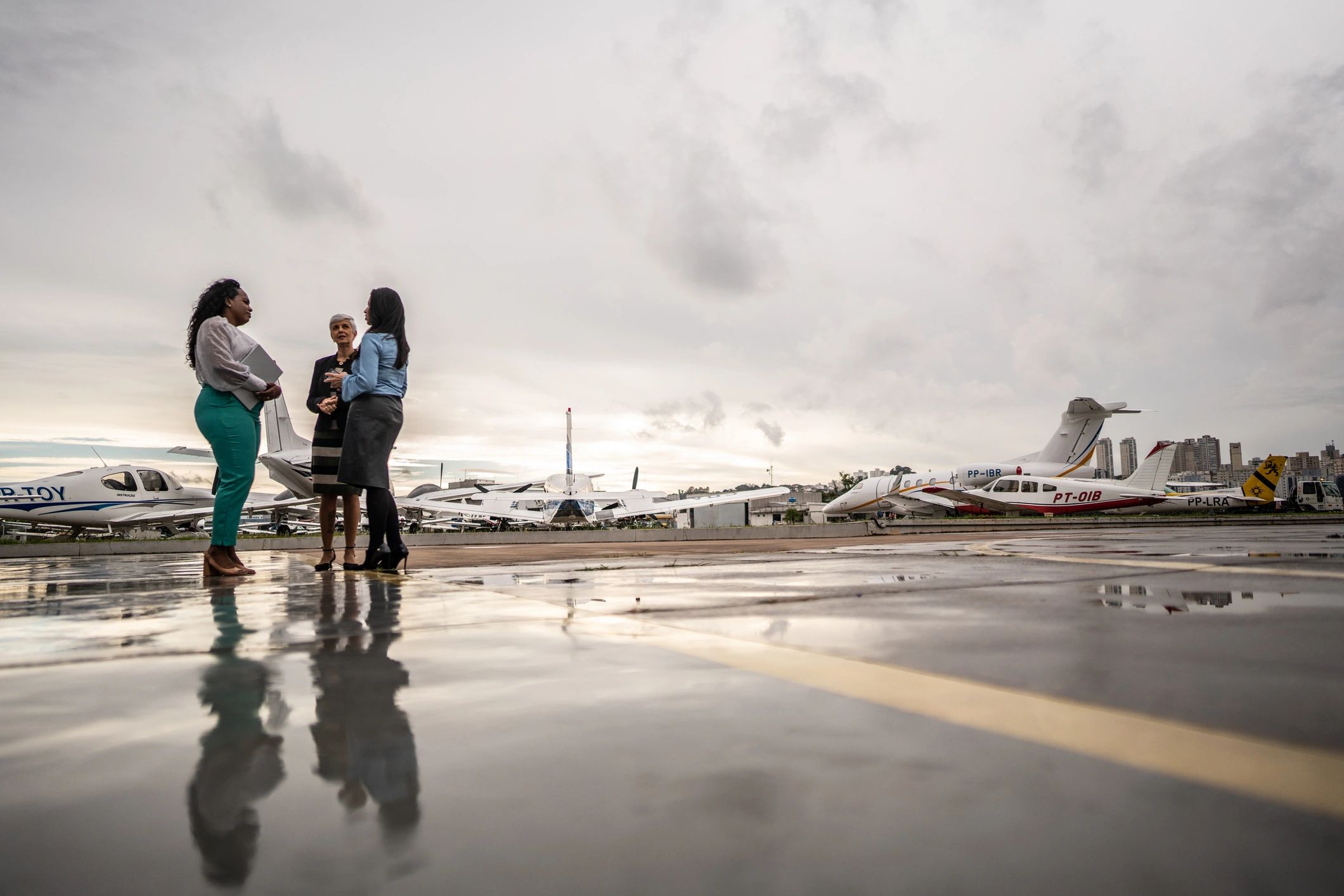 Guests and staff talking in an airport hangar before the experience